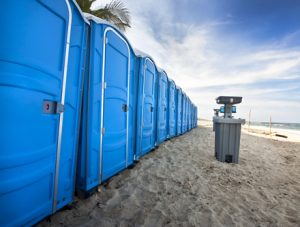 porta potties on the beach with a hand washing station