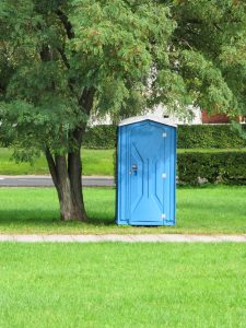 porta potty under a tree