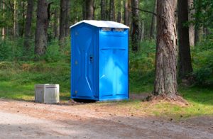 porta potty near a tree outdoors