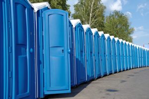 portable toilets in a concrete lot