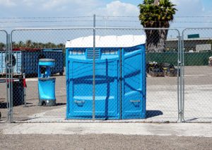porta potty and hand washing station in a lot