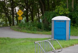 porta potty next to a road